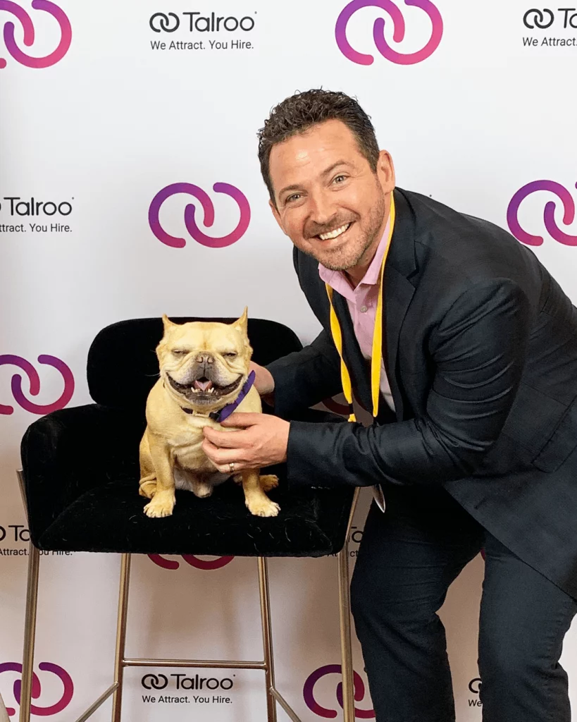 Talroo CEO Thad Price cuddles up to Hamlin the Frenchie